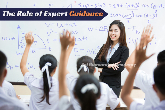 Engaged students raising hands in a classroom with a teacher offering expert guidance in physics, showcasing interactive learning at Peelamedu 